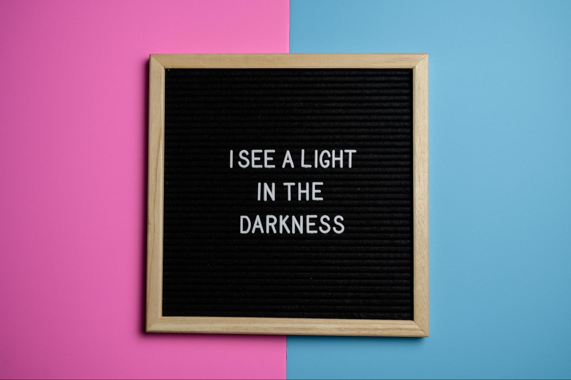Letter board spelling “I see a light in the darkness.