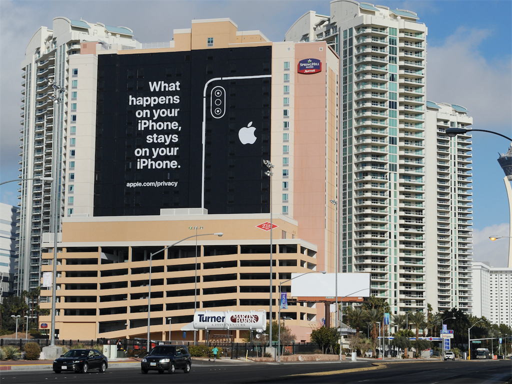 Apple ad in black and white on side of a building